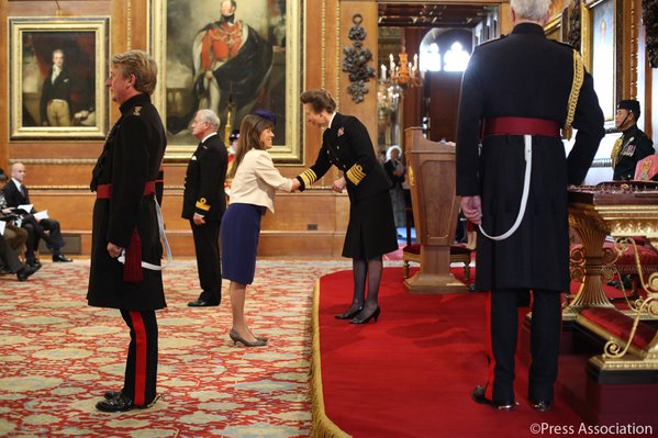 Mikey Argy receiving her MBE from Princess Anne