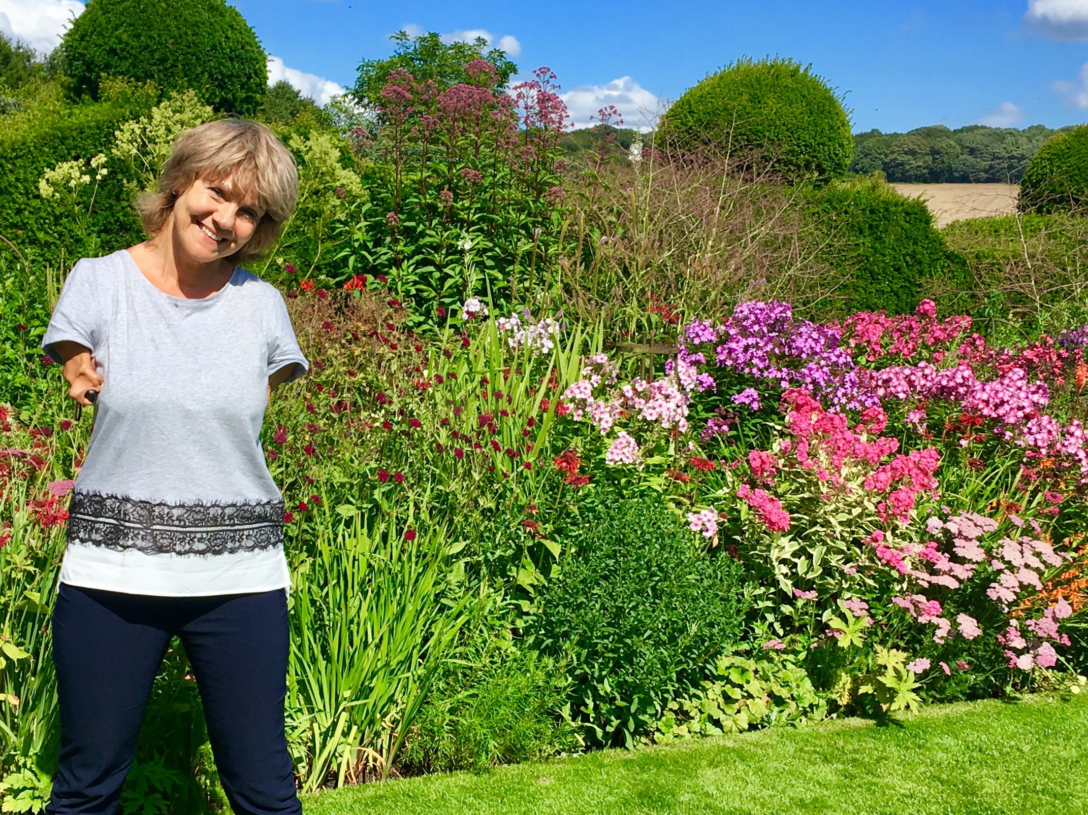 Carolyn Desforges in her colourful garden on a sunny day