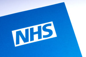Blue and white picture of the NHS logo