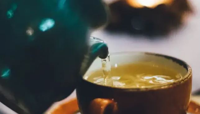 tea being poured into a cup