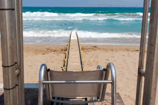 chair fixed to a wooden track which leads down a beach into the sea